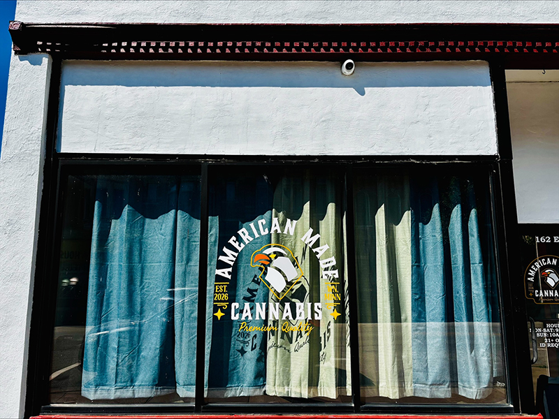 Exterior storefront of American Made Cannabis in Winona with logo on the front window