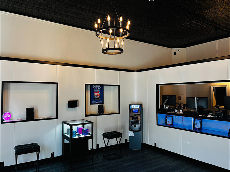 Interior of American Made Cannabis dispensary with display cases, seating, and service counter